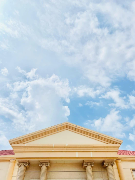 a very tall building sitting below a blue sky