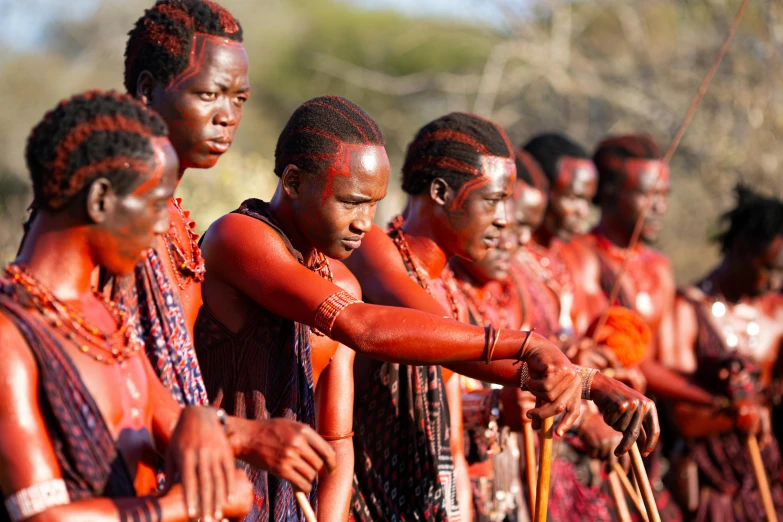 the women in colorfully painted clothes are practicing a painting