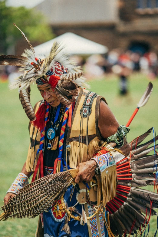 native indian man with feathers in traditional dress