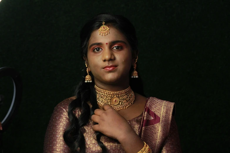 a woman is getting dressed in traditional garb