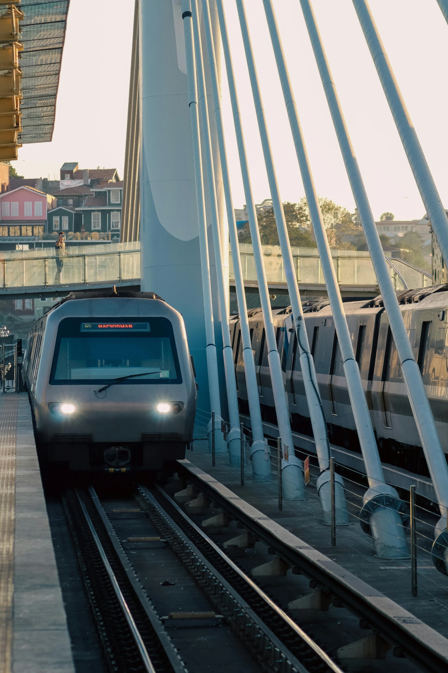 a silver train is passing over a bridge