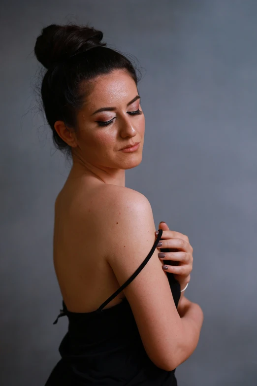 a woman poses for a portrait with her arms around her neck