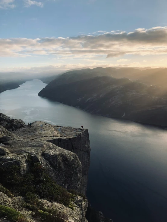 view of some water and mountains and a person on the edge