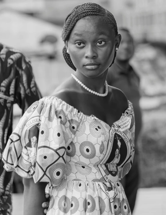 an african american woman with a beaded necklace