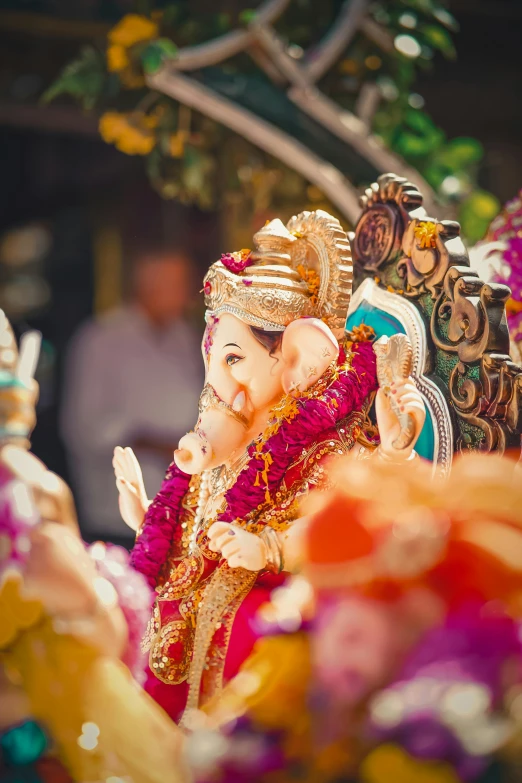 statue of ganesh with flowers around it