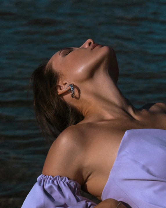 a woman laying on her back in the water