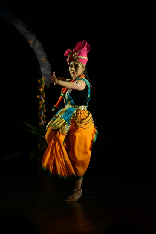 a woman wearing an elaborate head dress while holding a fan