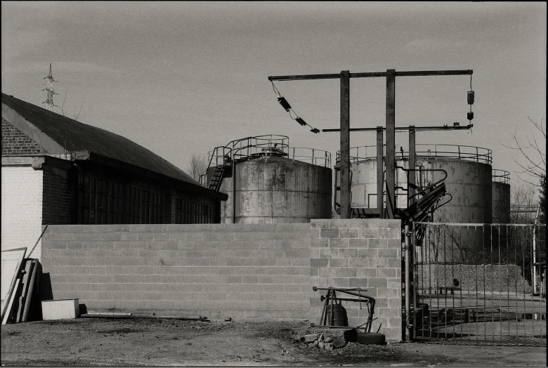 two silos in front of a brick wall