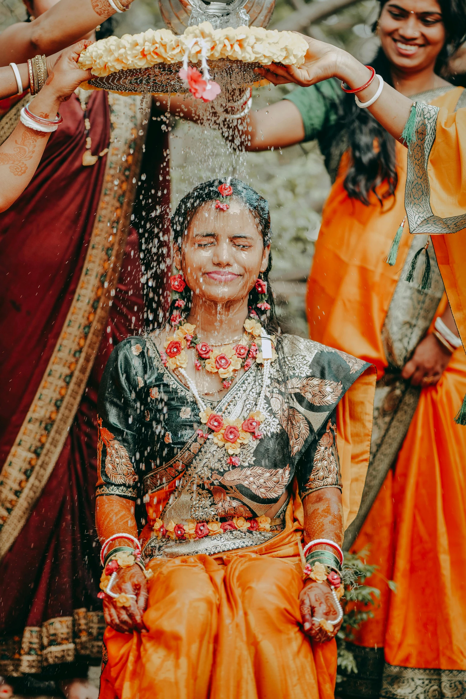 a couple being showered with water in front of other women