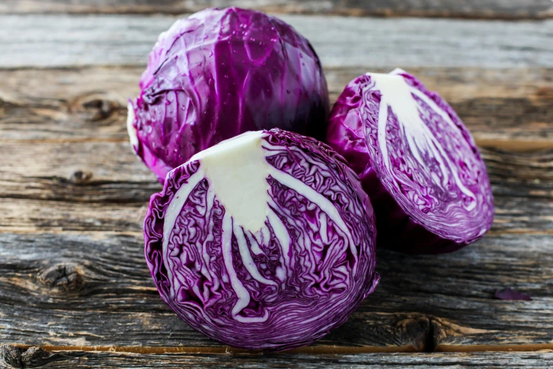 a red cabbage that is cut open and ready to eat