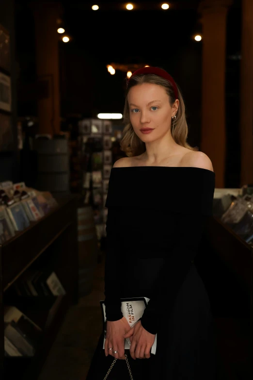 woman standing in a store and posing for the camera