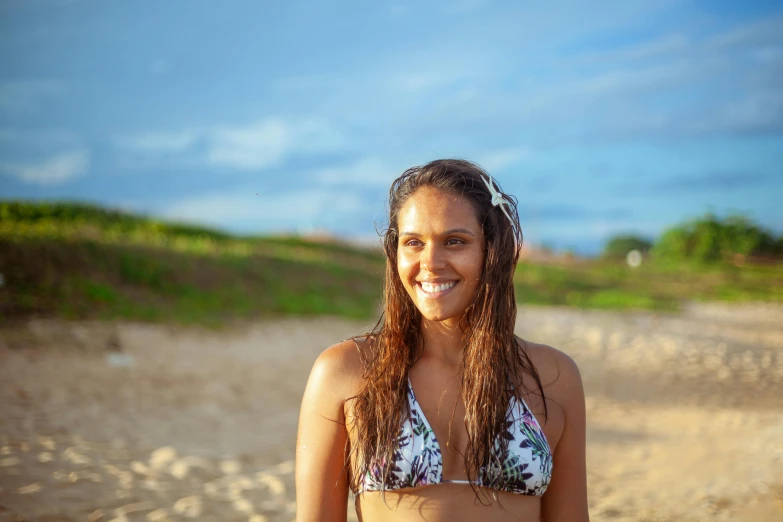 a close up of a person in a bikini on a beach