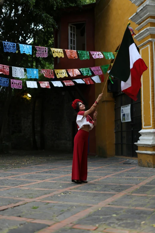 a woman is holding a flag with flags on the line