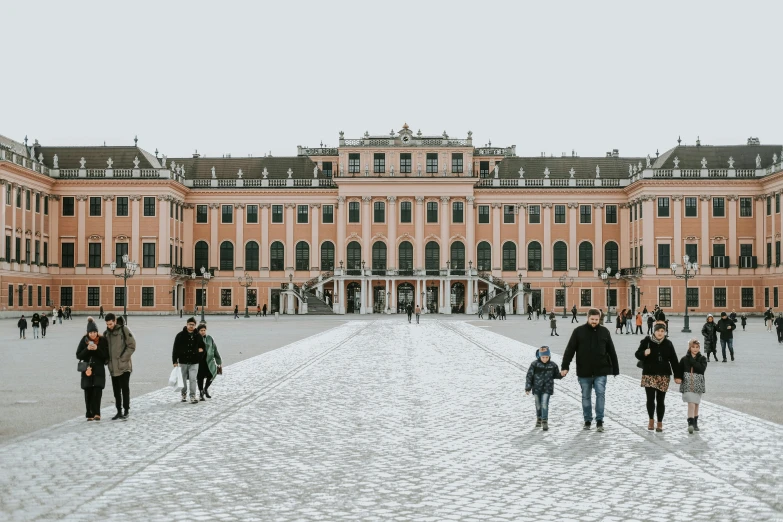 people are walking in the front of a building