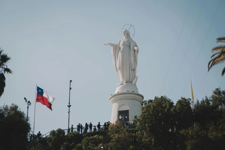 a large statue with a bunch of people near by