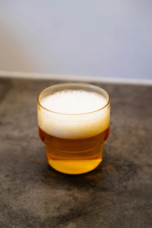 an empty glass is sitting on a counter