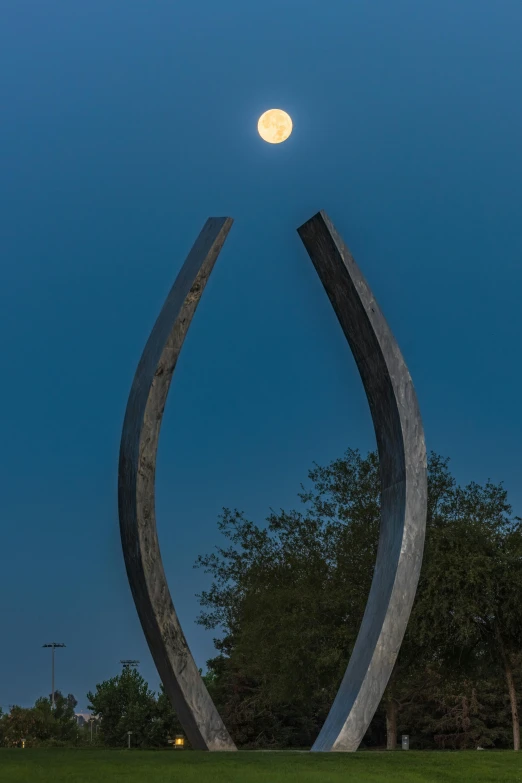 a large stone sculpture sitting on top of a field