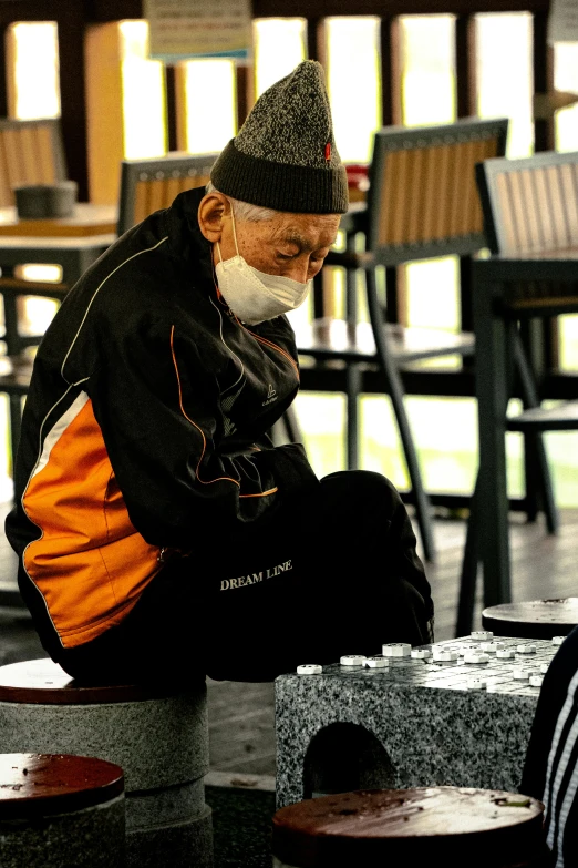 an old man sitting on top of a bench