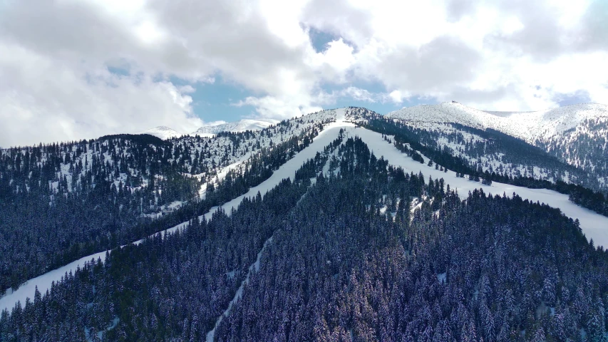 a ski slope on top of a mountain covered in snow