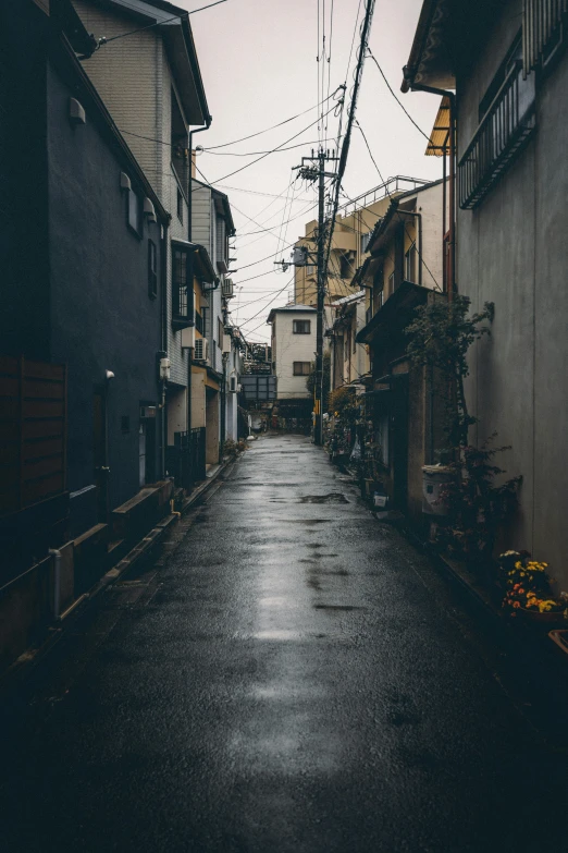 dark street with lots of electrical wires hanging over it