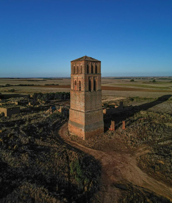 an old tower with multiple windows near the ocean