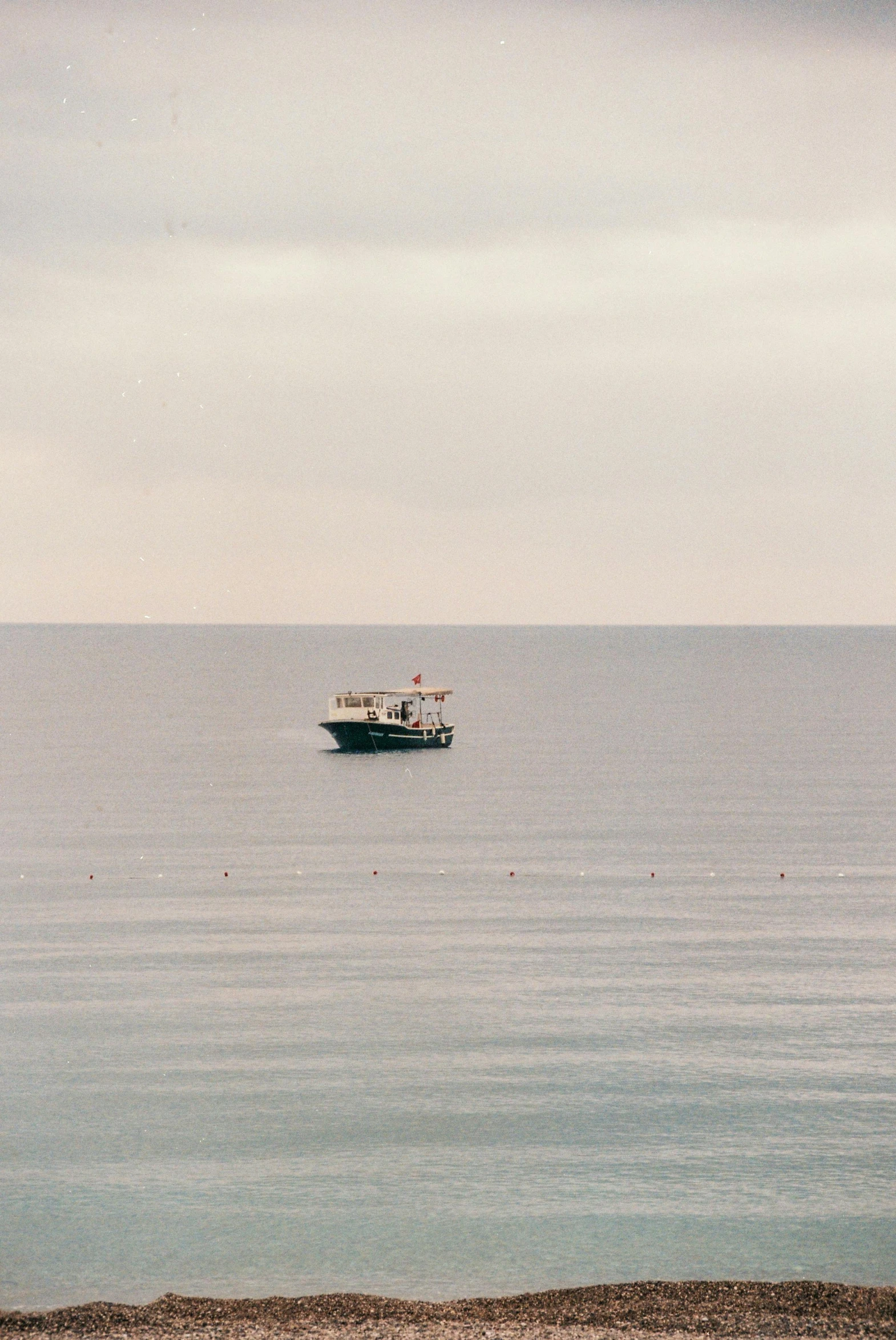 a cruise ship out on the ocean under a cloudy sky