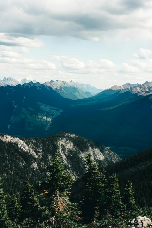 a view from top of a mountain that is full of green trees and mountains