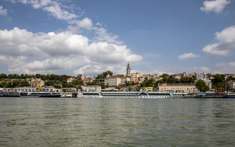 boats in the water and a sky filled with clouds