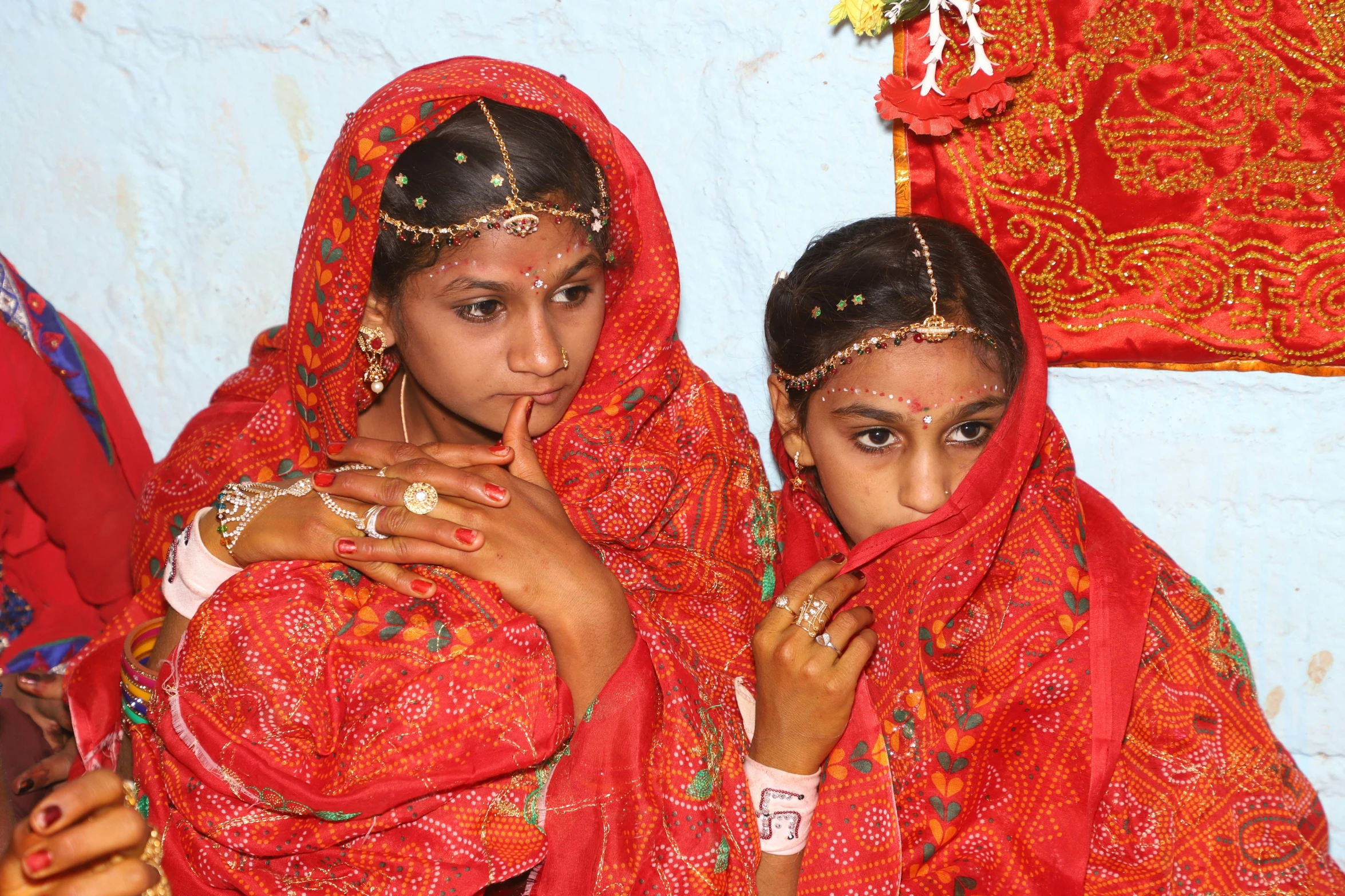 two indian woman are holding each other