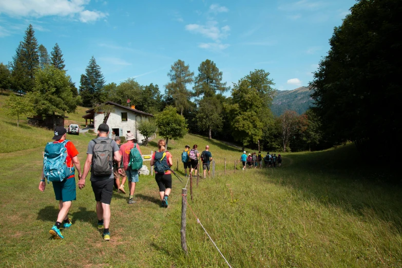 several people walking together down a path outside