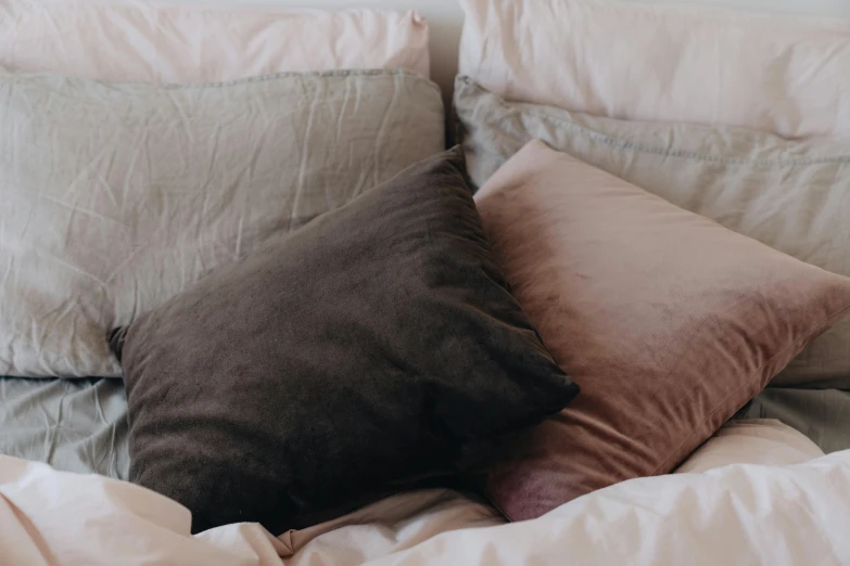 a white bed with two different pillows on top