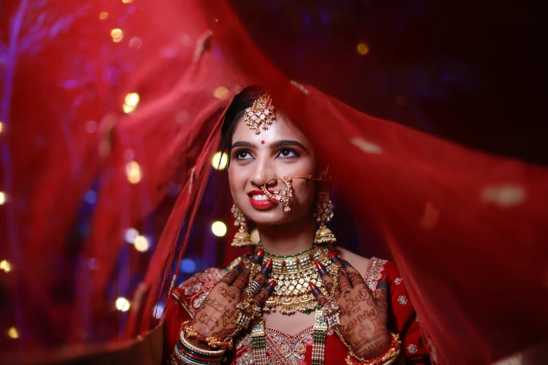 beautiful woman in indian garb getting painted her lips