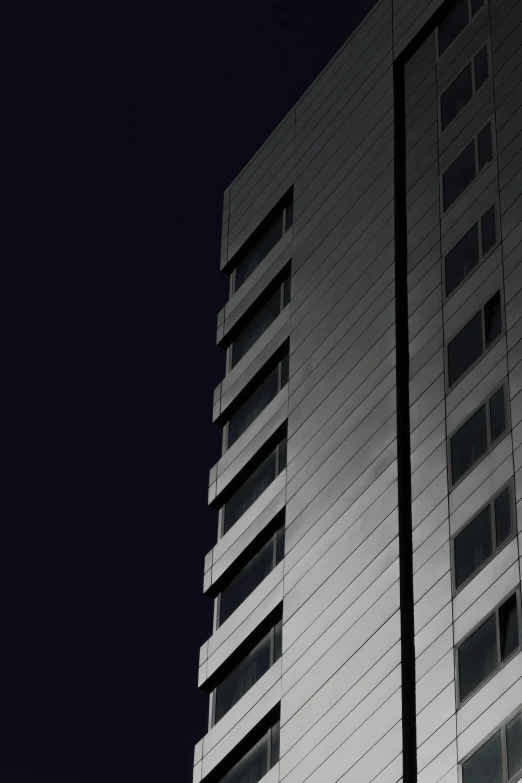 there is a very tall white building at night