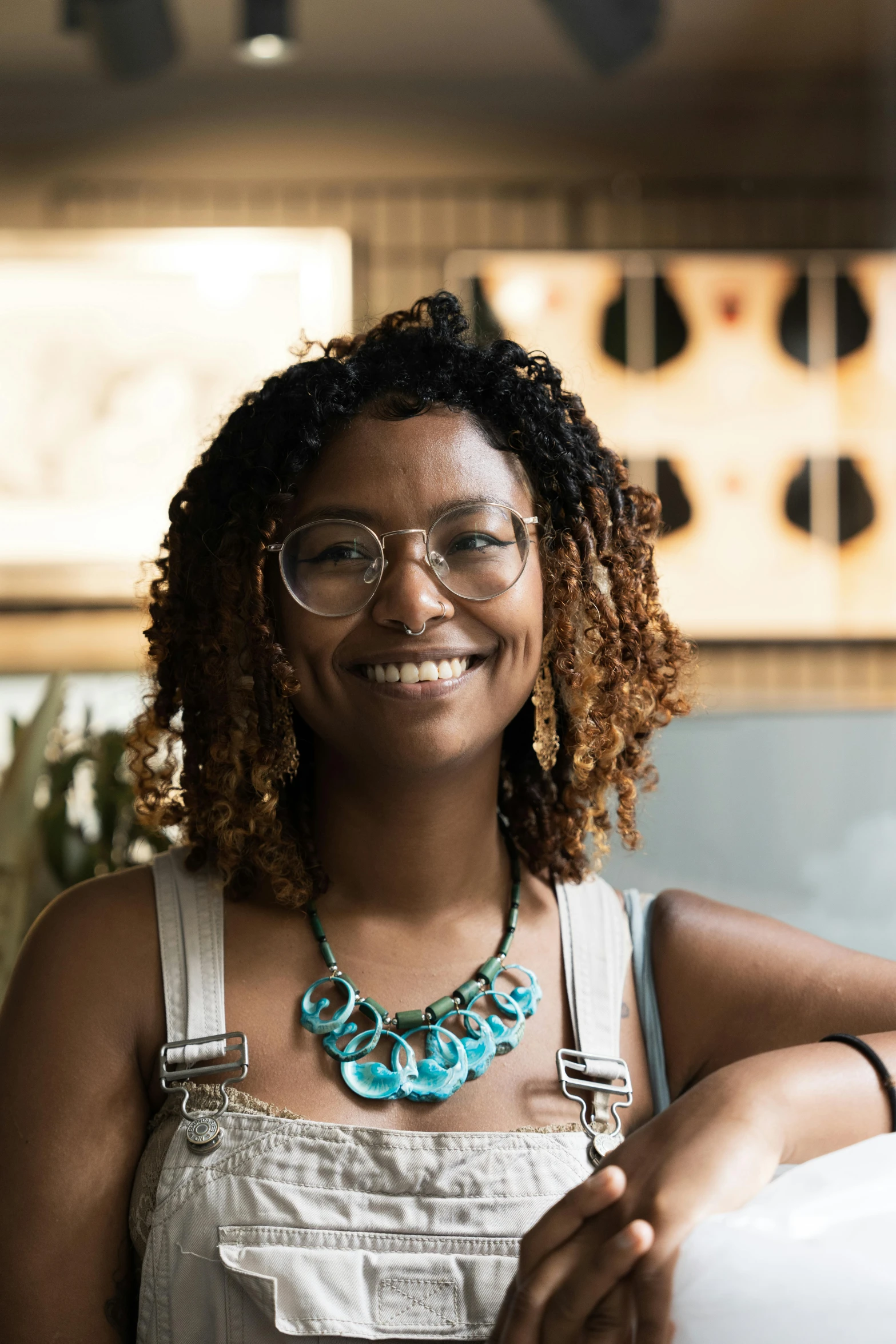 the woman wearing a white top is smiling for a picture