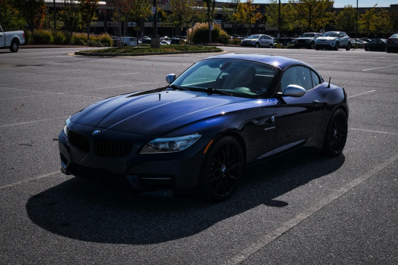 the black sports car is parked in the parking lot