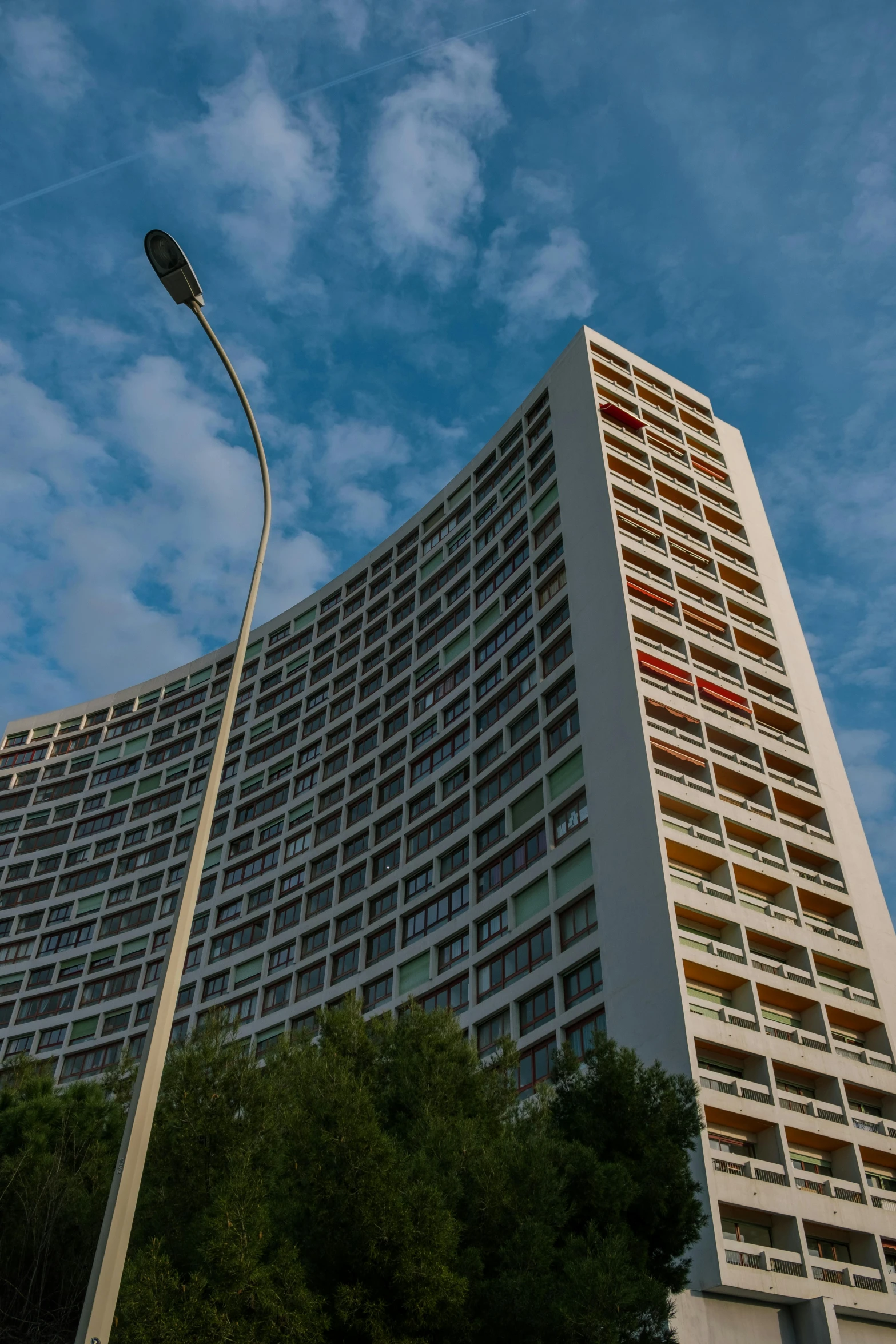 a tall tower with windows is against a blue sky