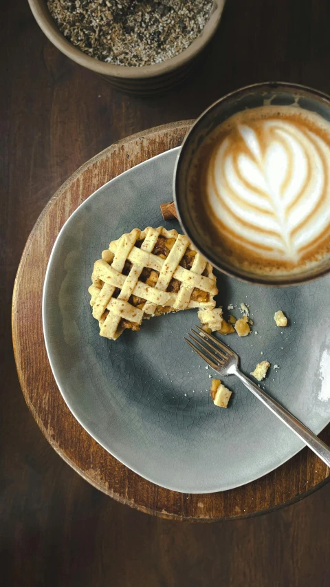 the dessert on the plate is next to a cup of coffee