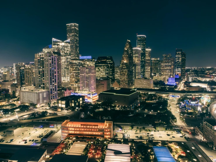 the city has large skyscrs and lights lit up at night