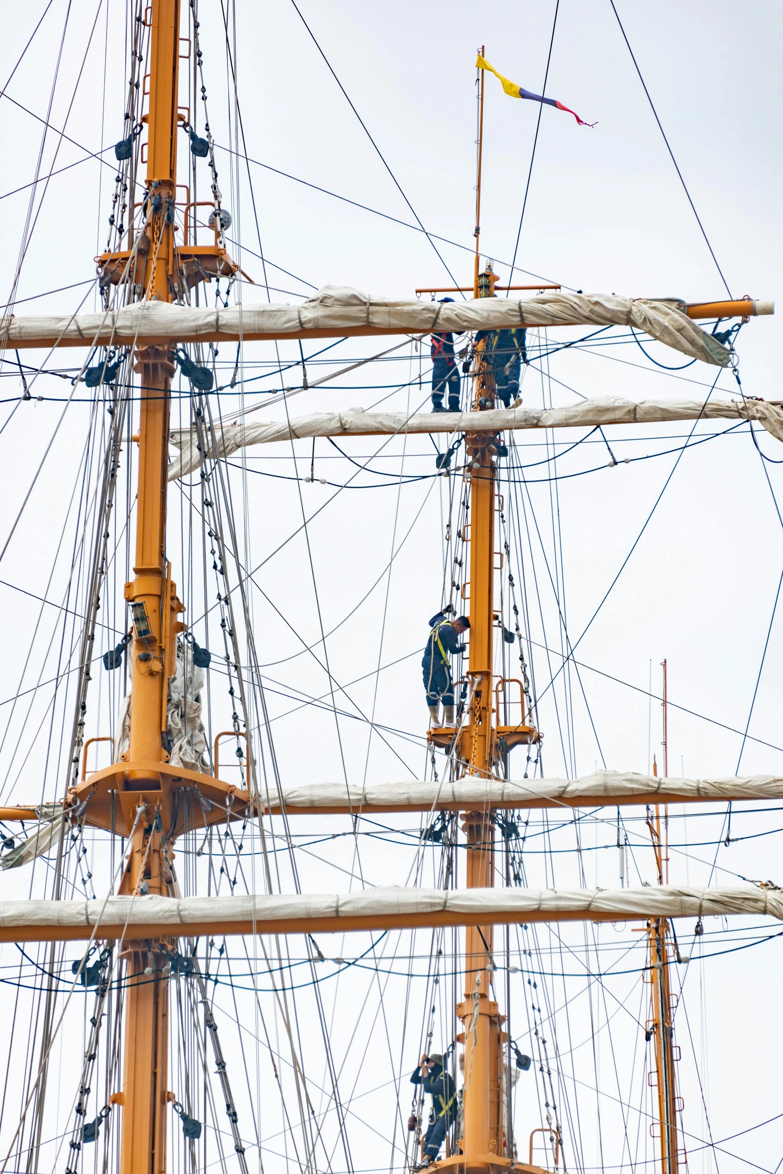 an old sailing ship with the masts being repaired