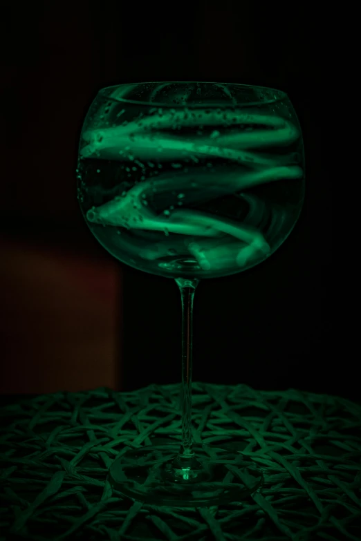 a green glow in a drink glass