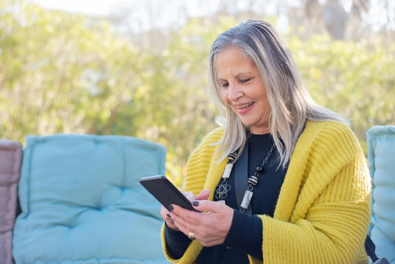 a woman with long hair is looking at her tablet