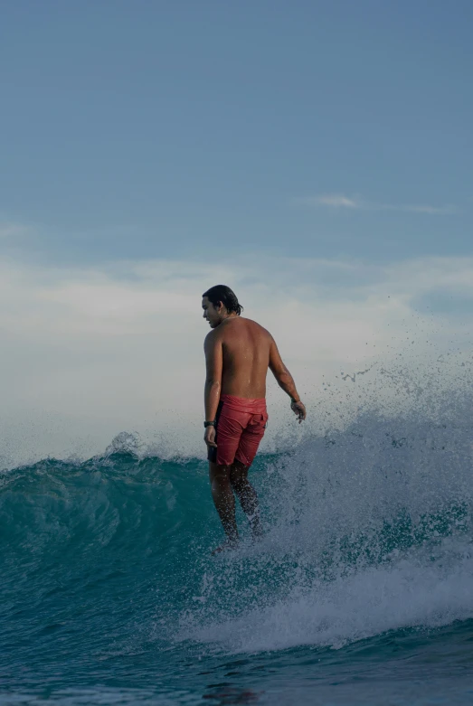 the man is riding his surf board on the water