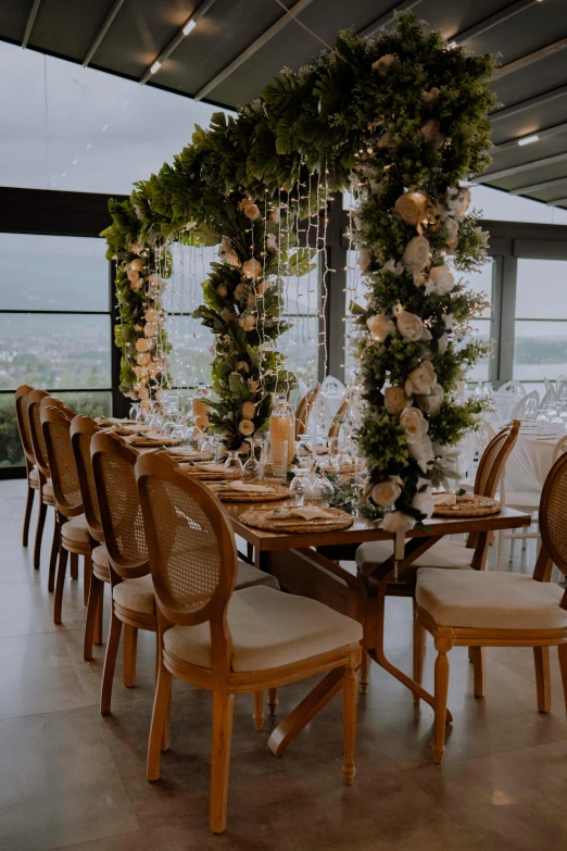 a large wooden dining table topped with lots of flowers