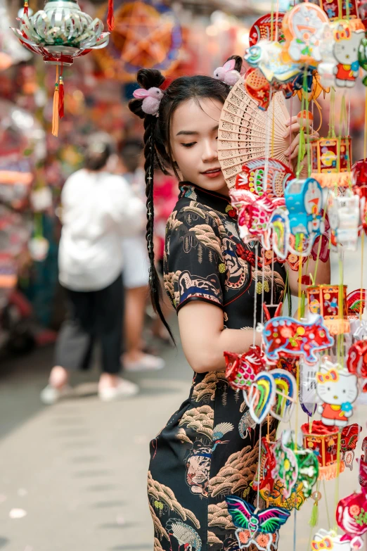 woman in traditional chinese dress at street market stall