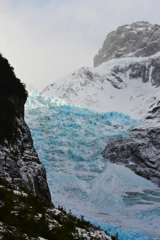 an ice covered mountain with snow