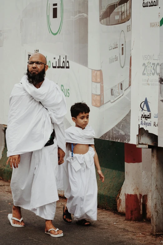 a little  and an older man on the street