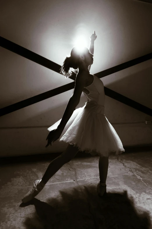 there is a female ballet dancer standing in an open room