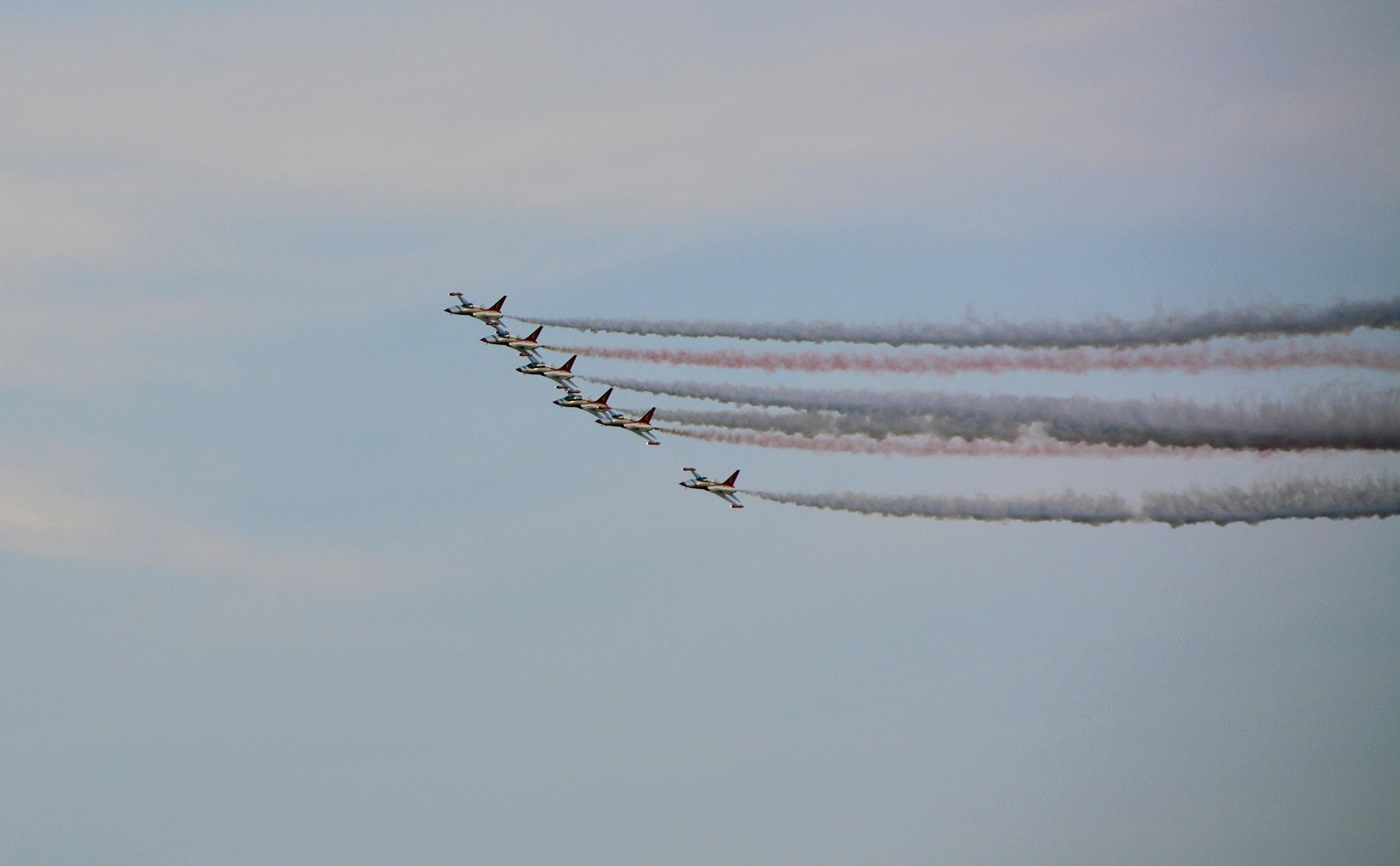 there are many airplanes that are flying in the sky