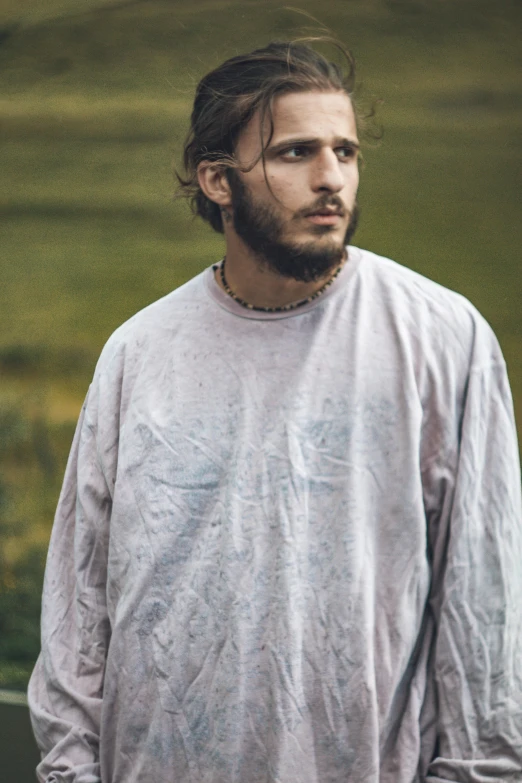 a man with long hair and beard wearing a sweater