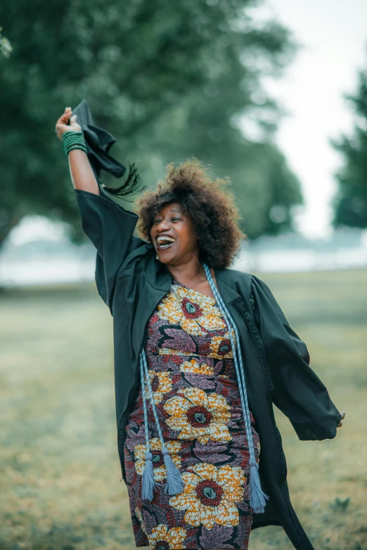 a woman holding her arms up to the sky